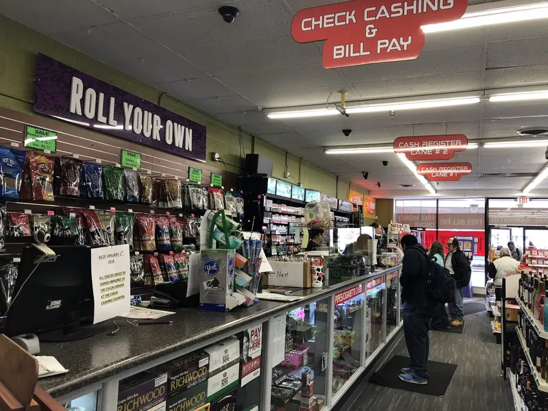 Our Check Cashing & Bill Pay counter and clearly marked register lanes make it easy for customers to handle their financial errands in one trip. Roll-your-own tobacco supplies line the wall right beside it, so you can knock out shopping and bill pay at the same time. Check Cashing and Bill Pay ceiling signs above cash register lanes at GS Vape in Barberton, Ohio.