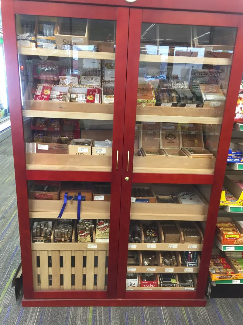 Red cigar humidor display cabinet stocked with premium cigars at GS Vape Barberton