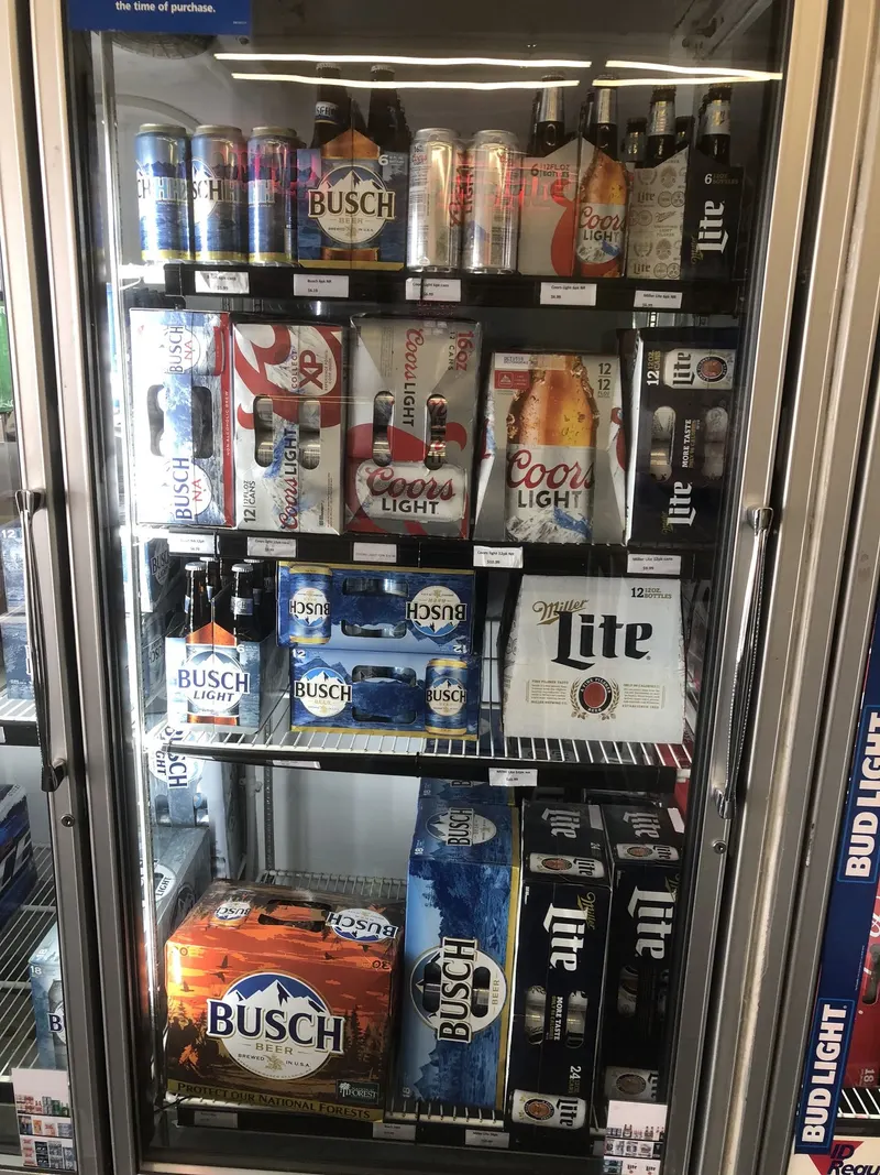 Our cooler stays fully stacked with the big domestic names, Coors Light, Miller Lite, and Busch, in every pack size from 12-packs to 30-packs. Whatever the occasion, this shelf makes it easy to grab a familiar favorite in seconds. Coors Light, Miller Lite, and Busch beer cases stocked in the cooler at GS Vape in Barberton, Ohio.