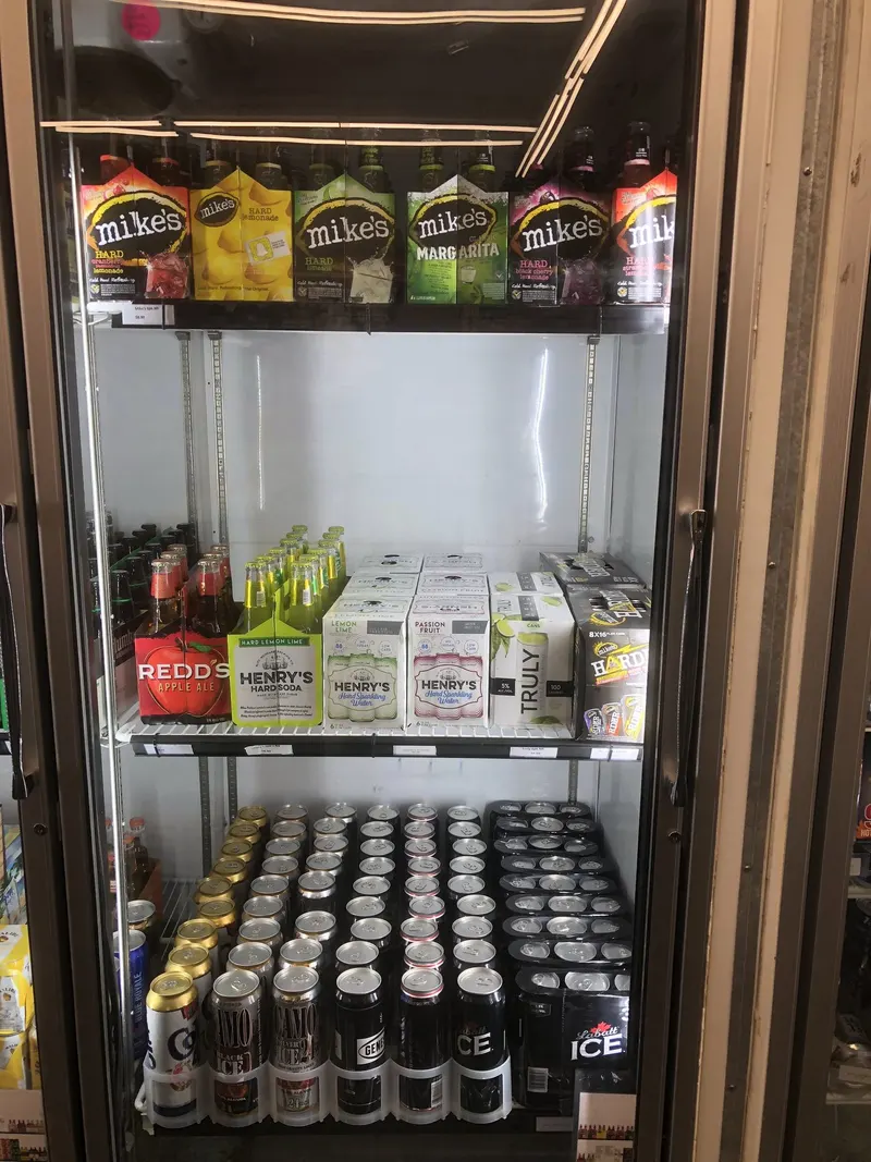 Beyond traditional beer, we keep a solid lineup of flavored malt beverages like Mike's Hard, Truly, and Henry's Hard Soda cold and ready to go. It's a favorite stop for customers looking for something fruity or lighter than a standard brew. Mike's Hard Lemonade, Truly, and hard seltzer flavored malt beverages in the cooler at GS Vape Beer & Tobacco in Barberton, Ohio.