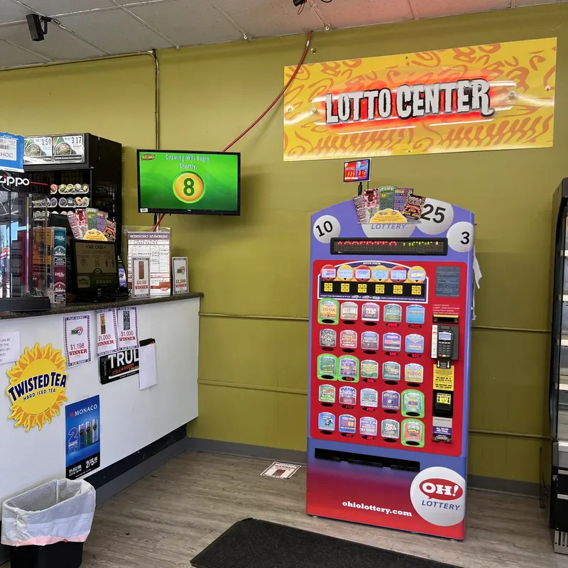 Our Lotto Center features a self-service Ohio Lottery vending machine loaded with instant games, Keno, and Mega Millions options. Grab a hard seltzer or Twisted Tea nearby and try your luck on the way out. Ohio Lottery self-service vending kiosk under the Lotto Center sign at GS Vape Beer & Tobacco in Barberton, Ohio.