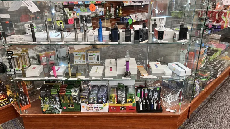 Vape mods, starter kits, and disposable pen displays in a glass case at GS Vape Beer & Tobacco in Barberton, Ohio.