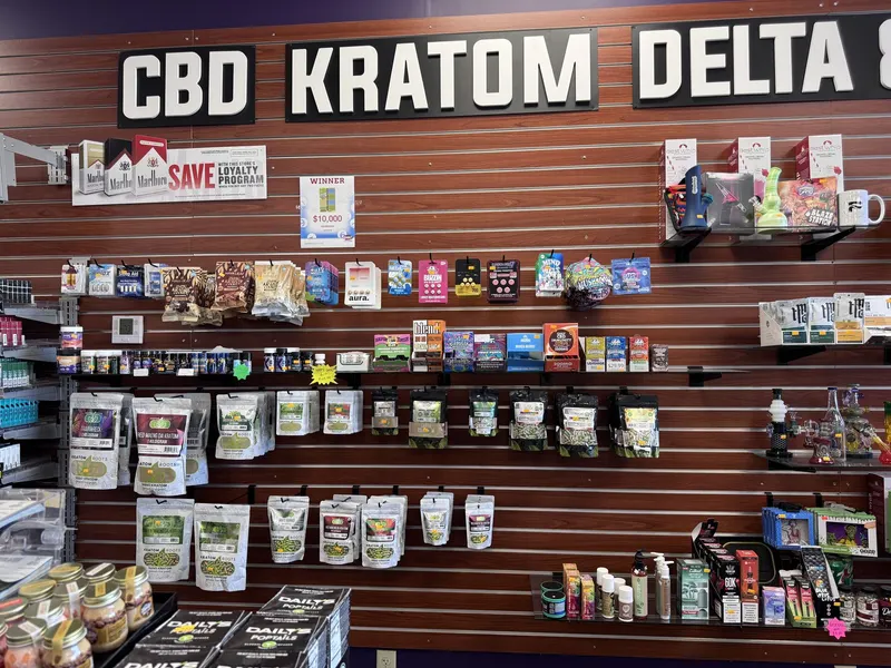 GS Vape Madison stocks a dedicated CBD, kratom, and Delta 8 wall featuring lab-tested products and loyalty program signage. It's one of the most requested sections for customers seeking natural wellness alternatives in Lake County. CBD, kratom, and Delta 8 product wall display at GS Vape in Madison, Ohio