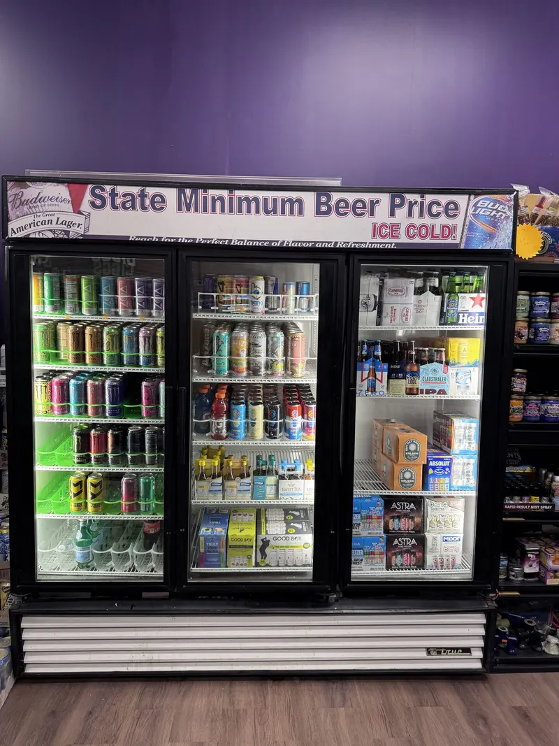 This cooler at GS Vape Madison highlights a curated craft beer and IPA lineup under the store's state minimum beer price signage. It's stocked with rotating regional and national craft selections. Craft beer and IPA cooler selection with state minimum beer price signage at GS Vape in Madison, Ohio