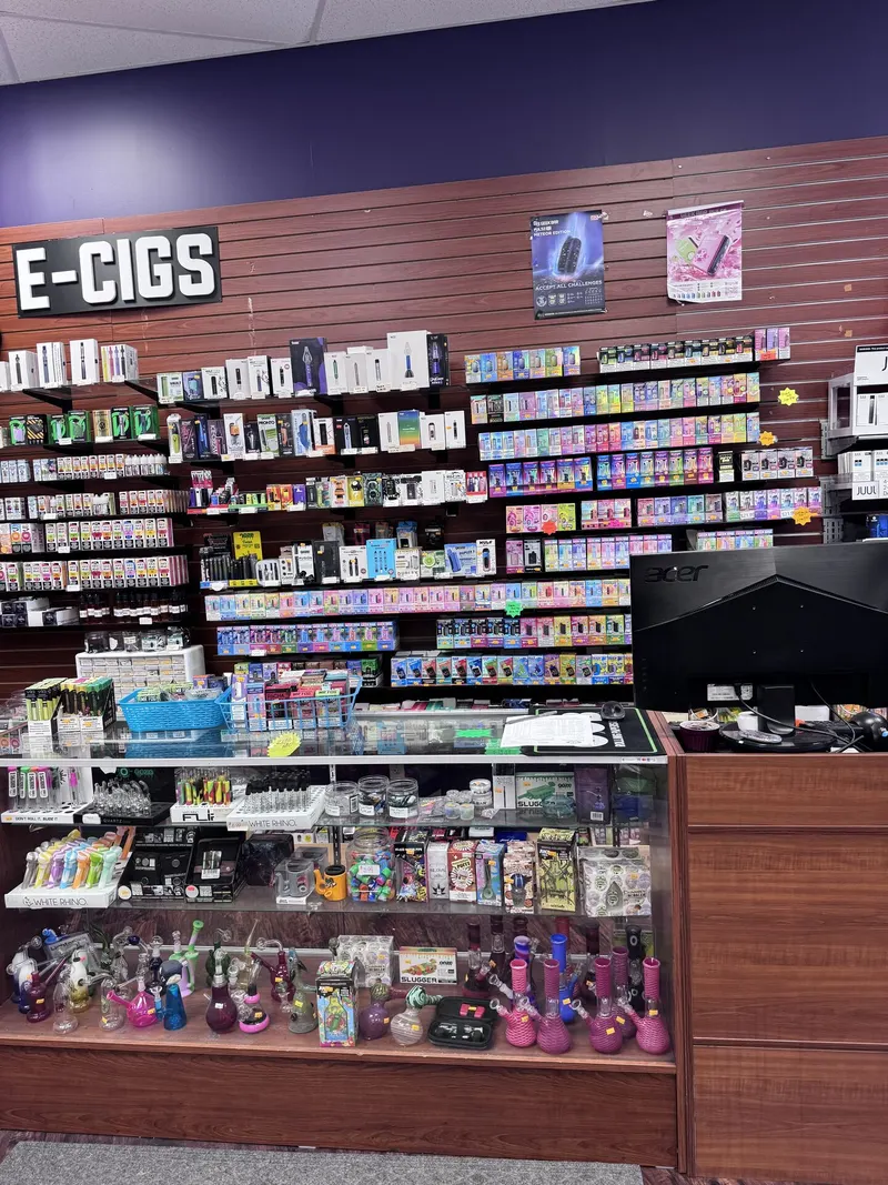 GS Vape Madison's E-Cigs wall is stocked with a wide range of vape devices and e-liquids above a glass case of glass pipes and water pipes. It's one of the most extensive vape selections in Lake County. E-cigs vape display wall and glass case at GS Vape in Madison, Ohio