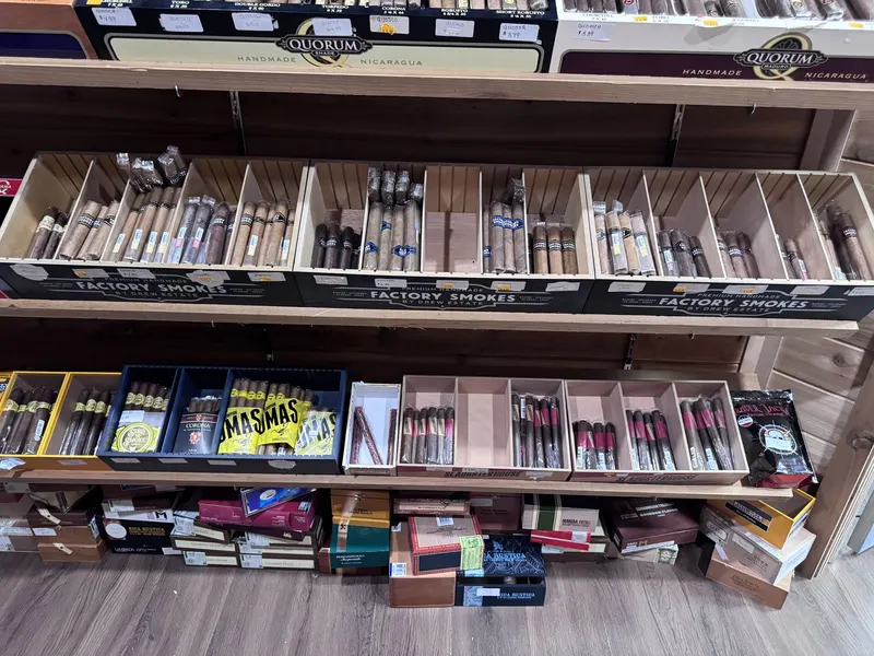 The Factory Smokes cigar bins at GS Vape Madison offer an affordable, wide-ranging selection alongside specialty brands like Mas Mas. It's a favorite section for cigar shoppers looking for everyday options. Factory Smokes cigar bin selection inside the humidor room at GS Vape in Madison, Ohio