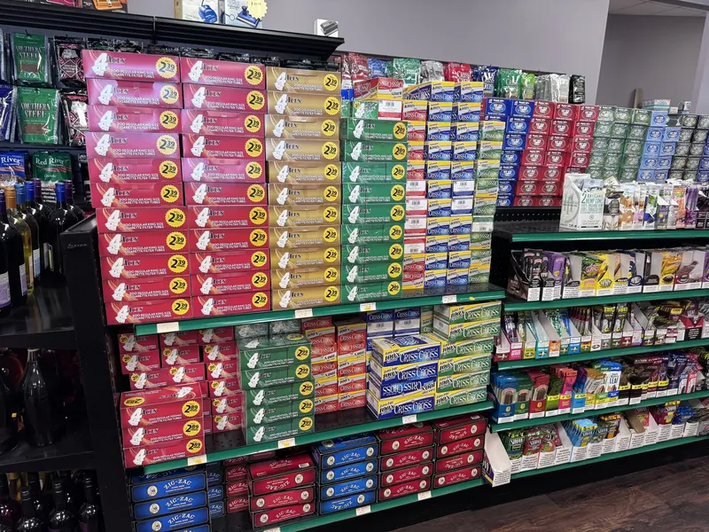 This wall at GS Vape Madison is stocked with rolling paper brands like Zig-Zag, Job, and Rizla in a full range of sizes. It's positioned near the wine aisle for easy access while shopping. Rolling papers wall display featuring Zig-Zag and Job at GS Vape in Madison, Ohio