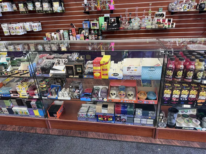 This case at GS Vape Madison showcases grinders, rolling accessories, and specialty smoking gear organized for easy browsing. It's located along the main smoke shop counter near the front of the store. Tobacco grinders and rolling accessories display case at GS Vape in Madison, Ohio