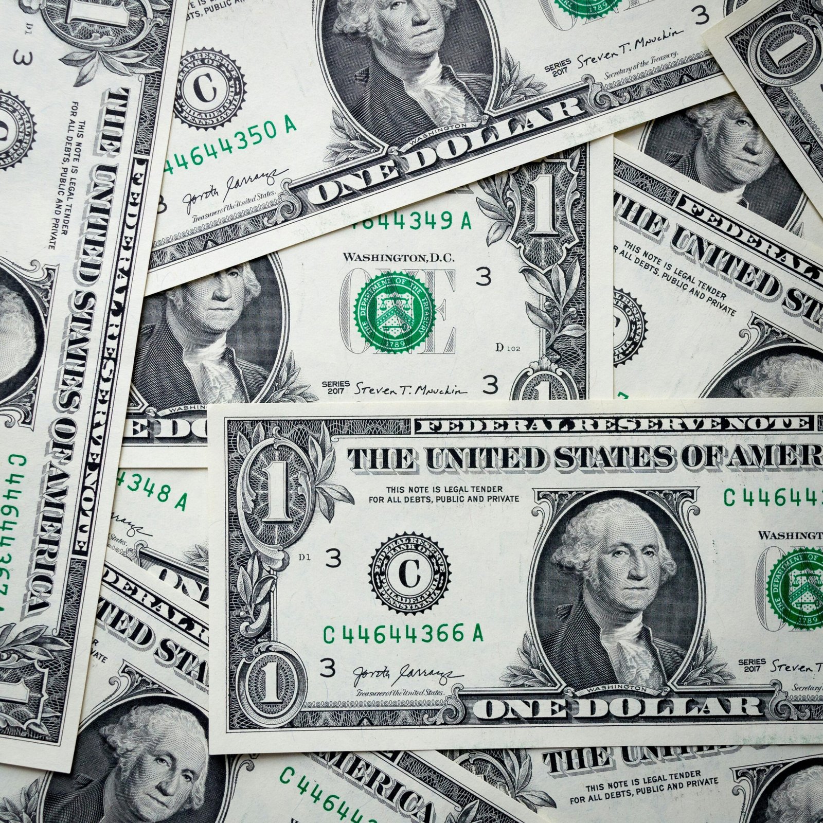 Detailed image of overlapping one dollar bills representing American currency and finance.